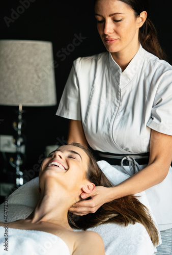 Young and healthy woman in spa salon. Traditional massage therapy and beauty treatments.