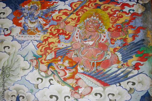Colorful traditional wall painting of wrathful deity riding garuda in Gangtey gompa or monastery, Phobjikha valley, Bhutan