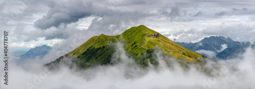 panorama view with the top of mount Fellhorngipfel in Germany among heavy clouds