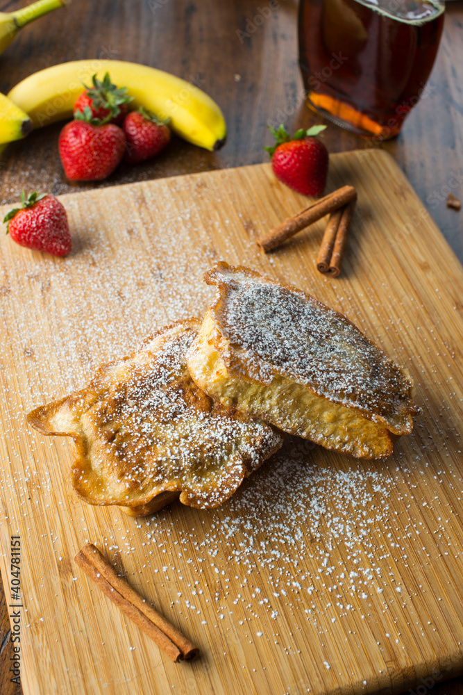 French Toast. Bread dipped in eggs milk and sugar then fried in cast iron skillet with butter topped with fresh fruit powdered sugar and maple syrup. Brunch or breakfast favorite. French Toast. Bread dipped in eggs milk and sugar then fried in cast iron skillet with butter topped with fresh fruit powdered sugar and maple syrup. Brunch or breakfast favorite.
