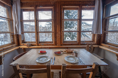 Wallpaper Mural Cozy breakfast in a cabin with a window on nature, with a snowy landscape in the background, working from home, holidays and dexterity from the city, in the countryside. Torontodigital.ca