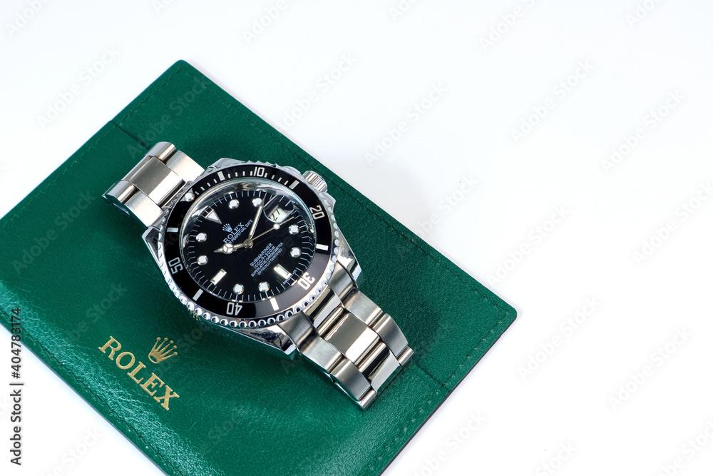 The Rolex vintage wristwatch ceramic bezel model black oyster perpetual  submariner date 39 mm display on the green leather background of Rolex crown  logo Stock Photo | Adobe Stock