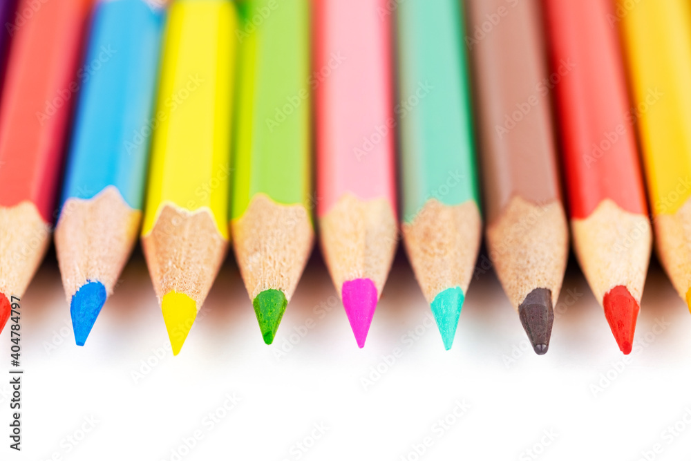 wooden bright colored pencils close up isolated on white blurred background wooden bright colored pencils close up isolated on white blurred background