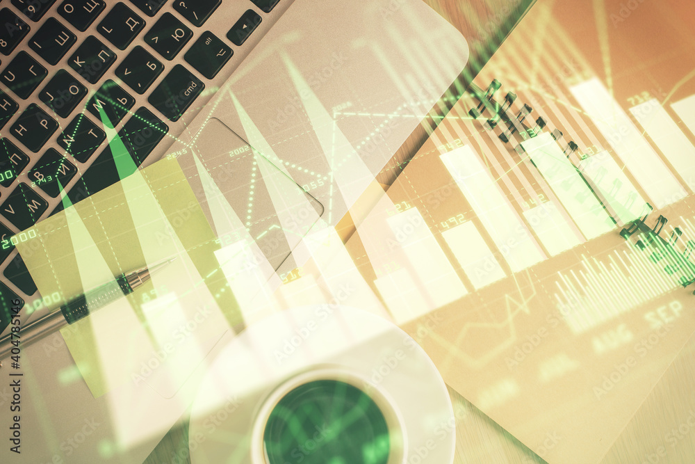 Stock market graph and top view computer on the table background. Double exposure. Concept of financial education. Stock market graph and top view computer on the table background. Double exposure. Concept of financial education.