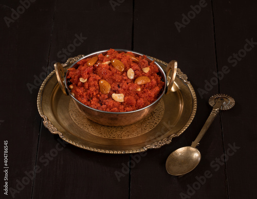 Indian Special Famous Winter Sweet Food Carrot Halwa or Gajar ka Halwa Served With Kesar Masala Milk  photo