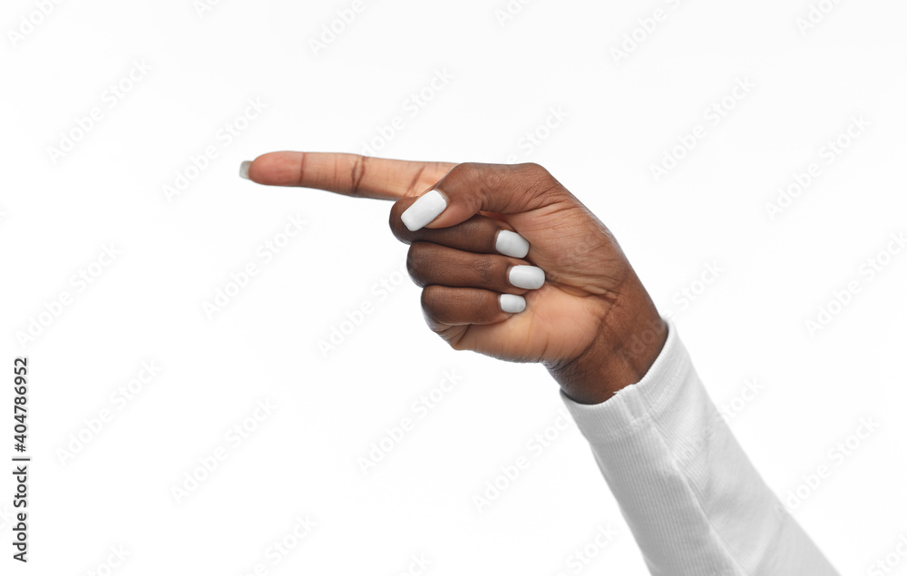 gesture and people concept - hand of african american woman pointing finger to left on white background