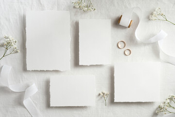 Vintage wedding invitations template. Top view blank paper cards, ribbon, golden rings. Wedding stationery set.