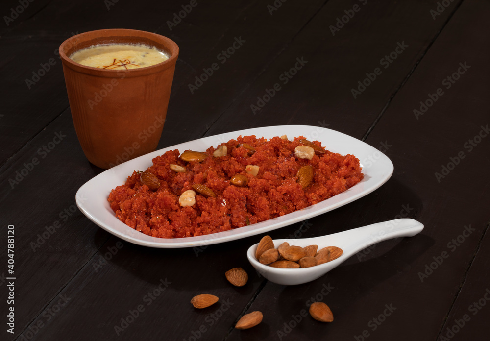 Indian Special Famous Winter Sweet Food Carrot Halwa or Gajar ka Halwa Served With Kesar Masala Milk Indian Special Famous Winter Sweet Food Carrot Halwa or Gajar ka Halwa Served With Kesar Masala Milk
