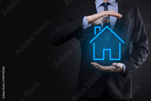 Real estate concept, businessman holding a house icon.House on Hand.Property insurance and security concept. Protecting gesture of man and symbol of house.