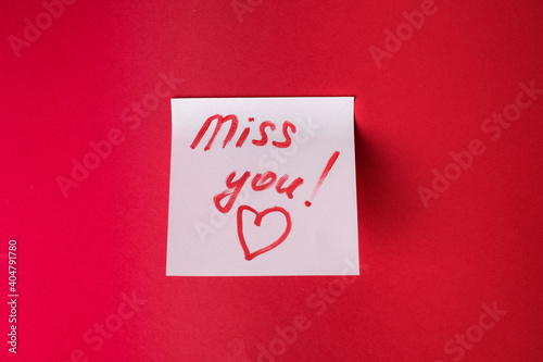 Sticker with love words written by pen, drawn heart and compliments for valentine s day at red background.