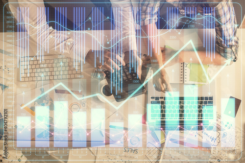 Double exposure of man and woman working together and financial graph hologram drawing. market analysis concept. Computer background. Top View. © peshkova
