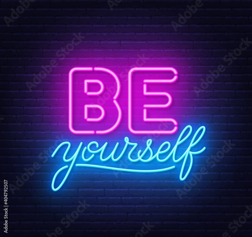 Be yourself neon quote on a brick wall. Inspirational glowing lettering.