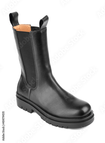 Women's shoes on a white background. Close up of a women's black leather chelsea boots on white background. Footwear for city, urban lifestyle or traveling. Concept of fashion, design and footwear.