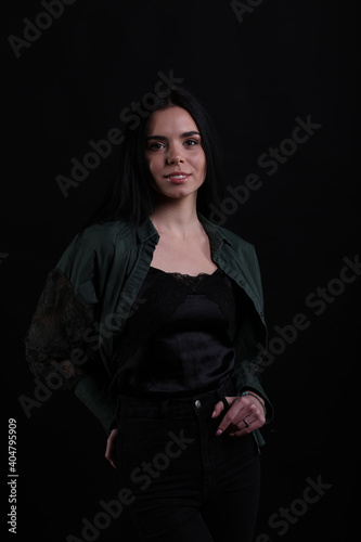Portrait of beautiful young brunette woman on black background © Сергей Луговский