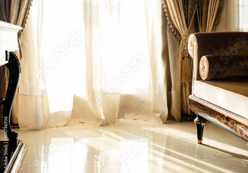 Brighly lit room with luxury furniture and curtains and soft daylight. photo
