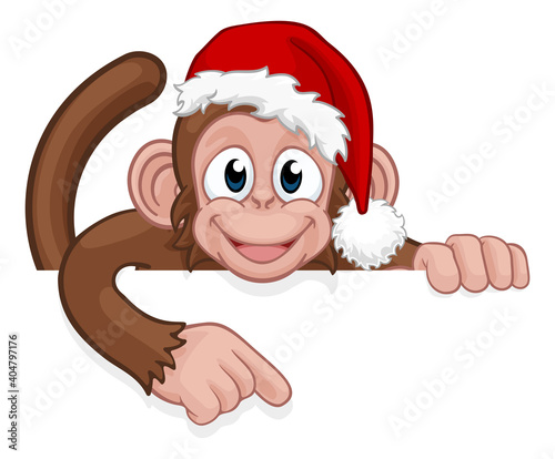 A Christmas monkey animal cartoon character in a Santa hat behind a sign peeking over a sign and pointing at it