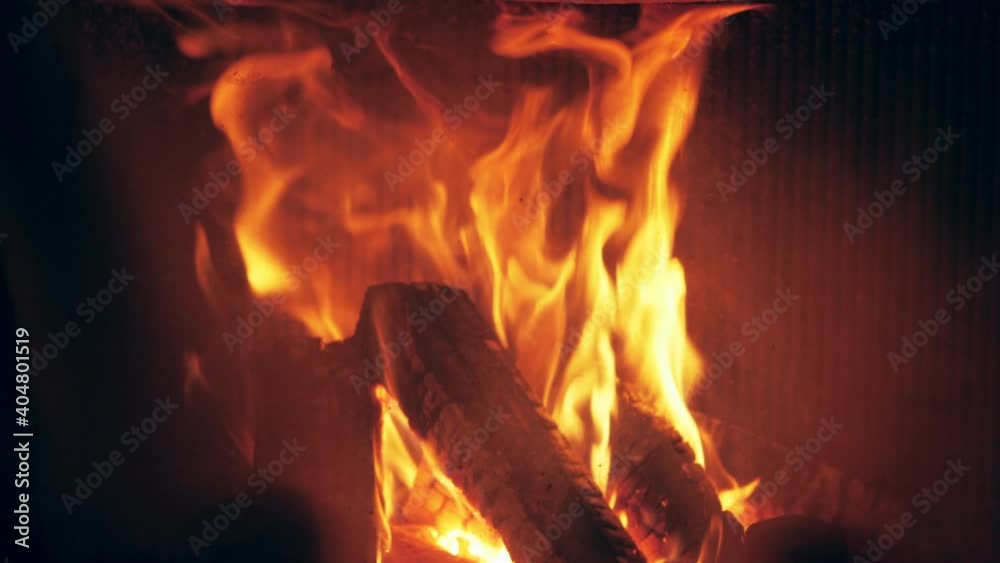Fire is burning in home fireplace background. Hot orange flames Bonfire in house Fire is burning in home fireplace background. Hot orange flames Bonfire in house