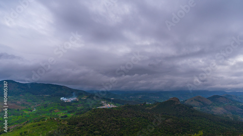 ooty village of green mountains landscape with sky and clouds . Ooty or Ootacamund or Udhagamandalam is a popular hill station in India