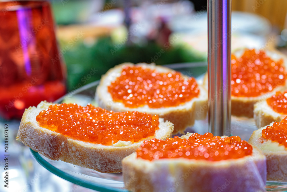 Sandwiches with red caviar and bread. Russian Red Caviar Crostini. French baguette, butter and red caviar. Sandwiches with red caviar and bread. Russian Red Caviar Crostini. French baguette, butter and red caviar.