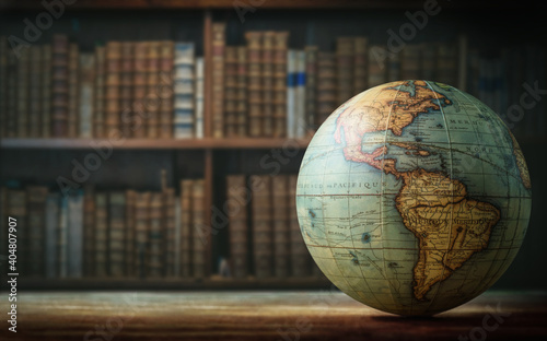 Old globe on bookshelf background. Selective focus. Retro style. Science, education, travel, vintage background. History and geography team. photo