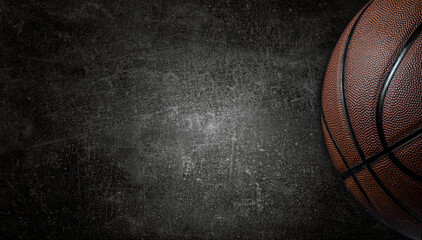 Basketball ball on dark concrete wall texture background. Background for product display, banner, or mockup