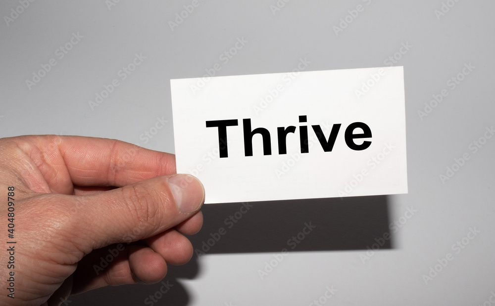 Message on the card THRIVE in hands of businessman. Message on the card THRIVE in hands of businessman.