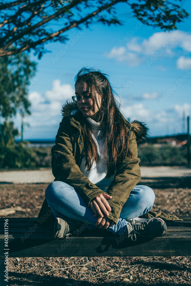 A girl sitting on a park bench A girl sitting on a park bench