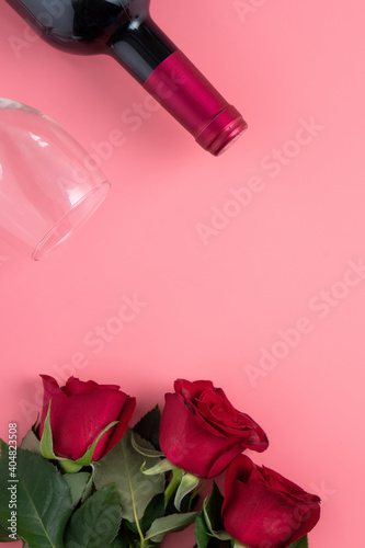 Valentine's Day dating gift with wine and rose concept on pink background