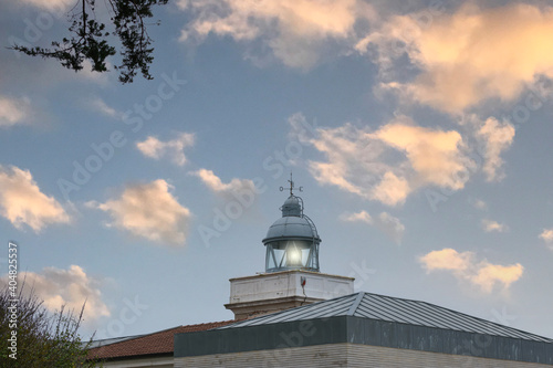 maritime lighthouse lit with sunset sky