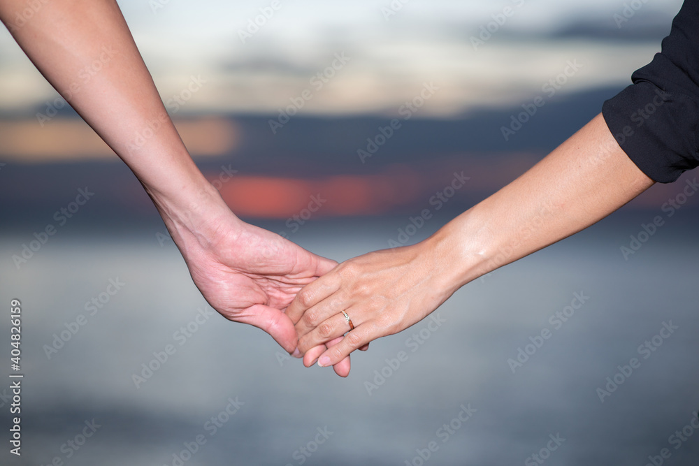 couple holding hand walking near the beach couple holding hand walking near the beach