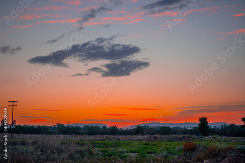 Orange cloudy sunset at the city