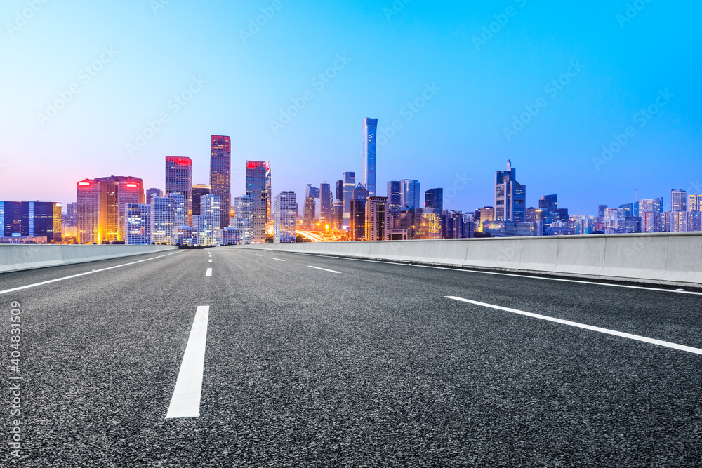 Asphalt road and modern city commercial buildings in Beijing at night,China.