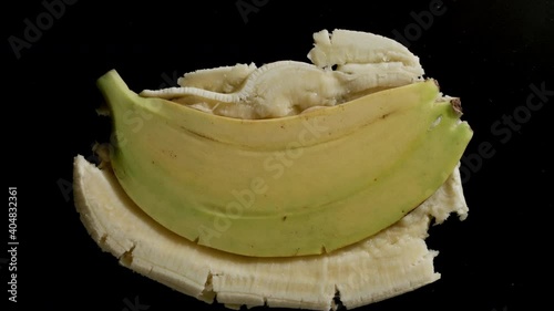 Crushing Single Whole Banana On A Black Background