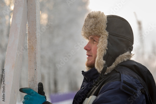 Portrait of a fitter in a blue jacket at a construction site © ads861