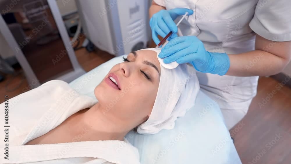 Beautician makes facial contouring with injections. Beautician makes facial contouring with injections.