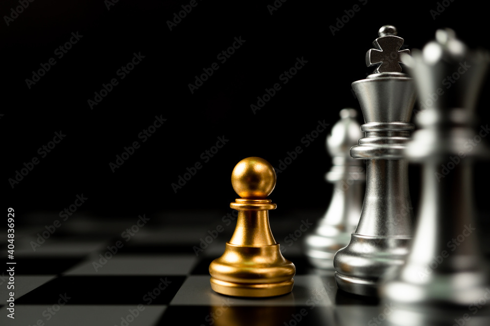 Golden Chess pawn standing in front of other chess, Concept of a leader must have courage and challenge in the competition, leadership and business vision for a win in business games Golden Chess pawn standing in front of other chess, Concept of a leader must have courage and challenge in the competition, leadership and business vision for a win in business games