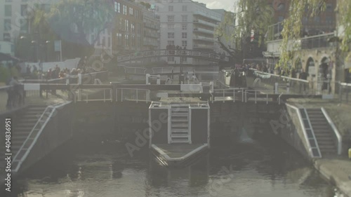 A houseboat leaving Camden locks in London photo