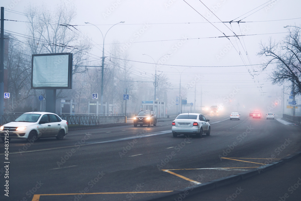 Cars on the road in fog city