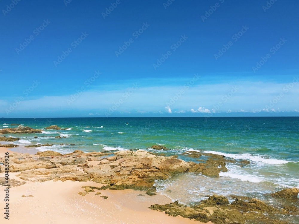 Scenic View Of Sea Against Blue Sky