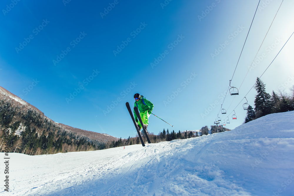 Skier in mountains. Professional skier athlete skiing of ski resort.Winter vacation and sport concept.