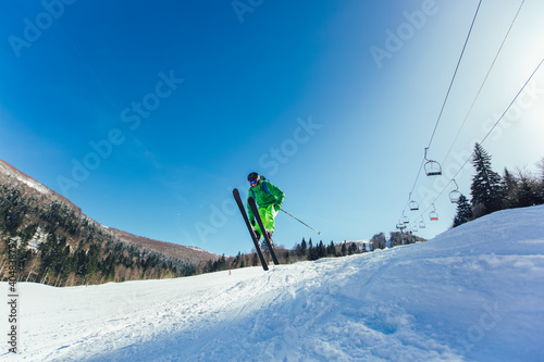 Skier in mountains. Professional skier athlete skiing of ski resort.Winter vacation and sport concept.
