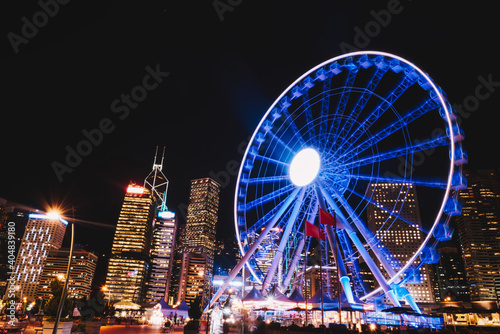 Glowing Ferris wheel in night city