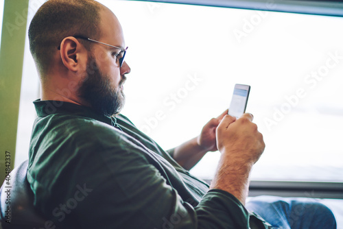 Man sufring net on smartphone during break photo