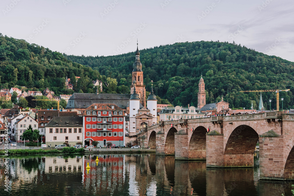 Heidelberg old bridge over Neckar river after sunset in summer