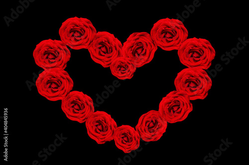 Heart-shaped frame of red roses on a black background. The Concept Of Valentine s Day