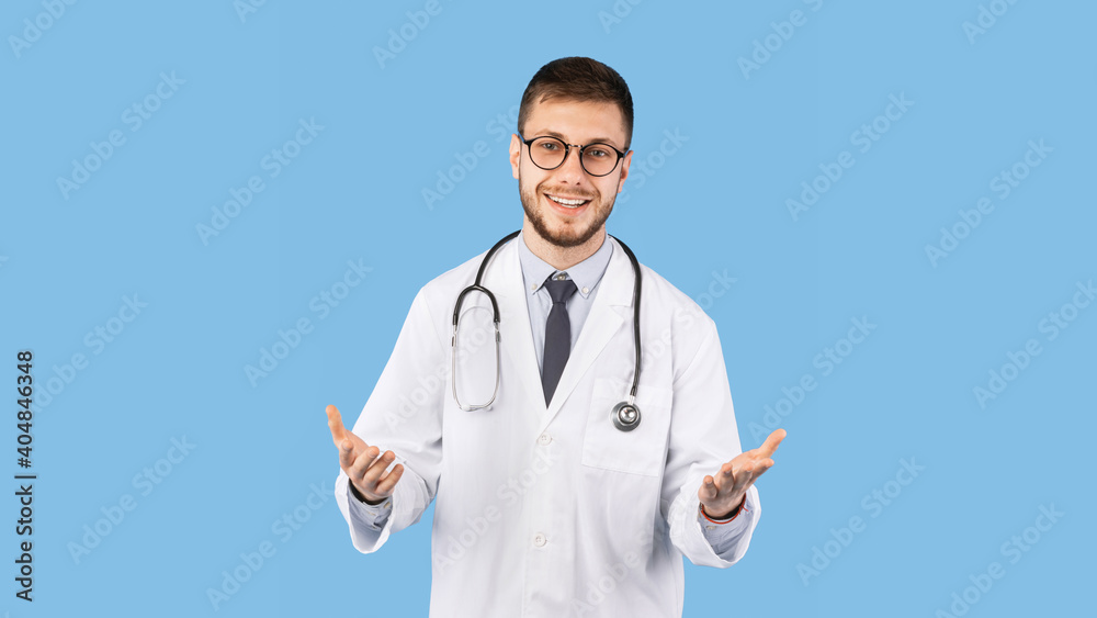Cheerful Male Doctor In Uniform Talking To Camera, Blue Background Cheerful Male Doctor In Uniform Talking To Camera, Blue Background