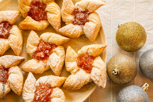 Joulutorttu, traditional finnish christmas pastry with marmalade on the plate and christmas balls photo