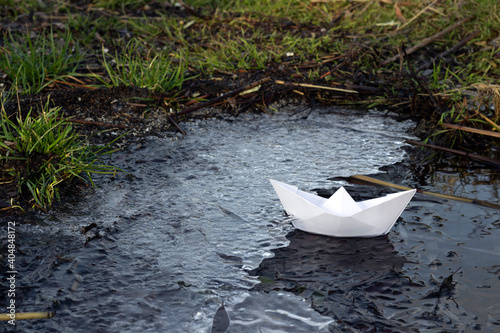 paper boat on the coast with ice, the concept of travel and difficulties