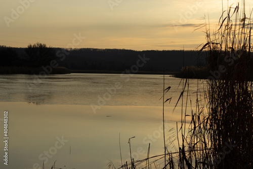 small river with freezing primary ice at dusk