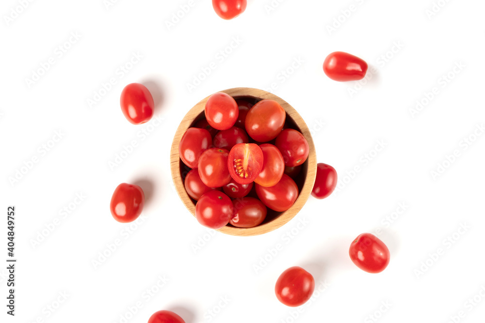 Top view of cherry tomatoes in a wooden bowl isolated on white background Top view of cherry tomatoes in a wooden bowl isolated on white background